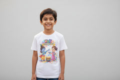 White t-shirt with cartoon characters and colorful text on a wooden surface with confetti.